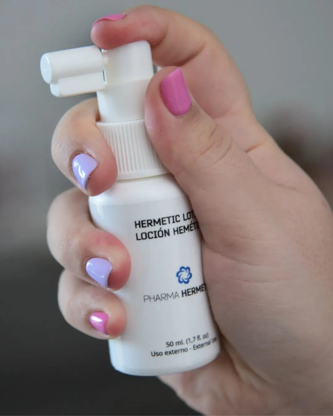 Hair Treatment SP55 Pro lotion in spray held in the hand